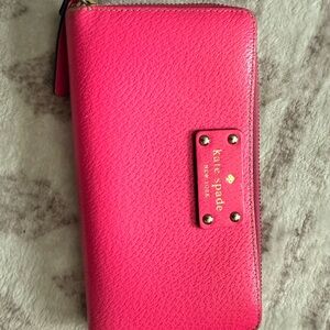 kate spade pink pebbled zip-around wallet with gold logo plate